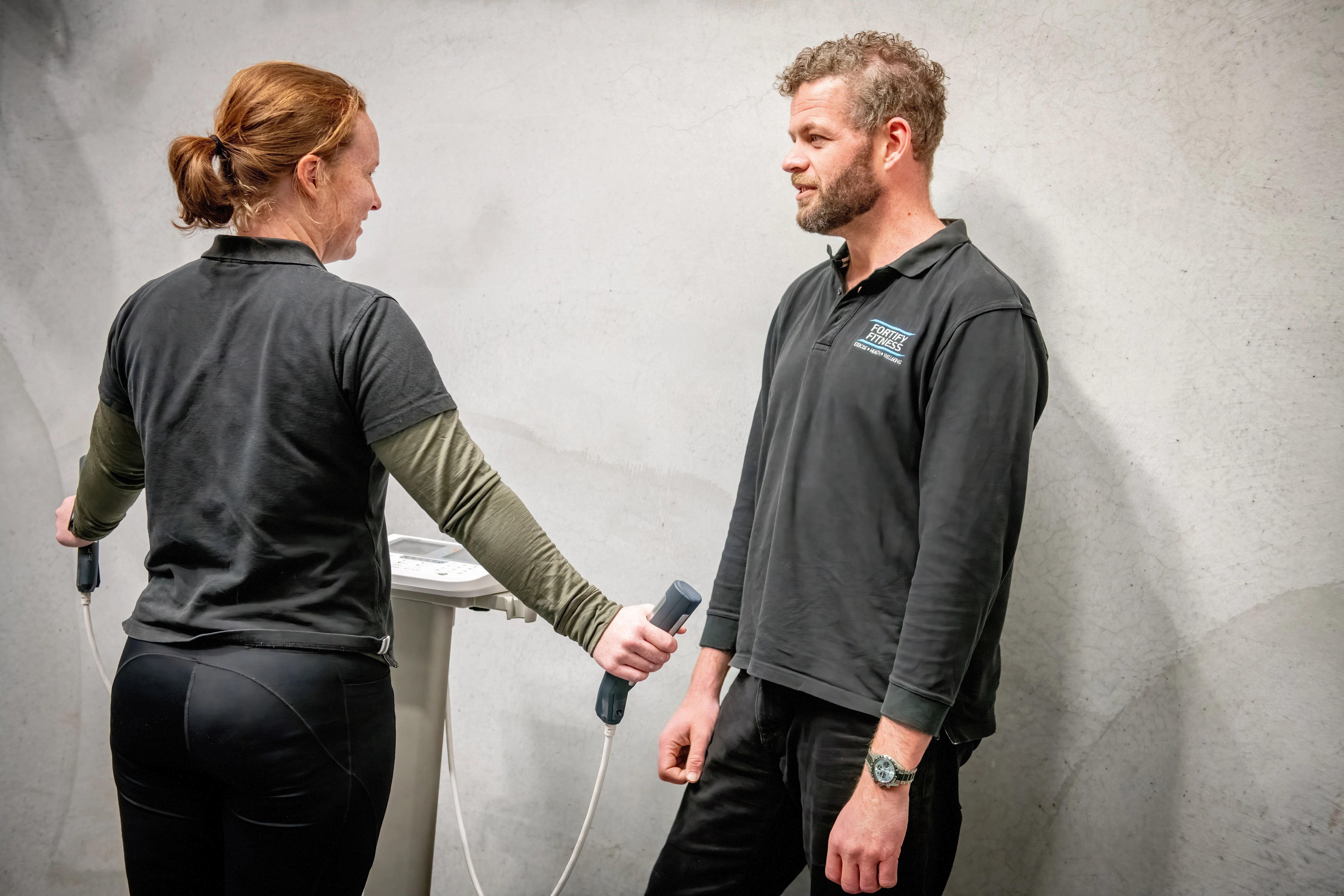 Fitness professional conducting a body composition assessment at Fortify Movement & Health